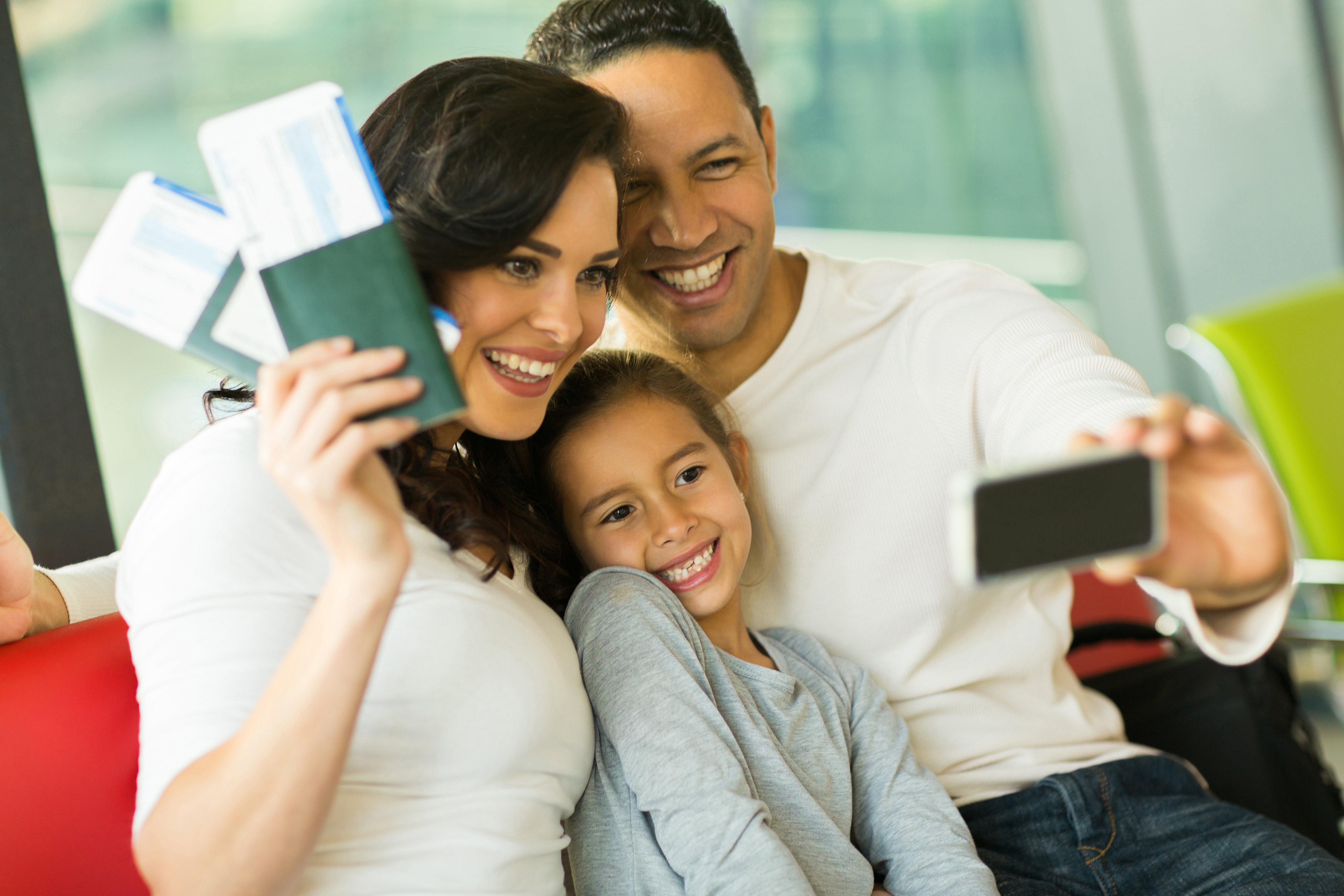 family_taking_selfie_with_plane_tickets
